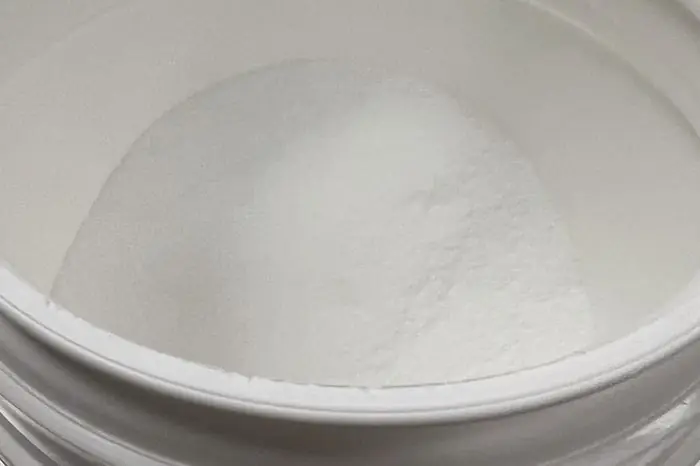 Creatine monohydrate powder in an open tub